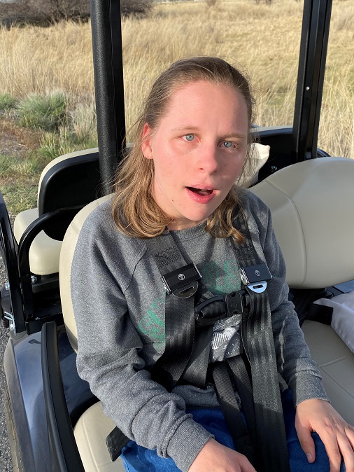 Jamie buckled in the golf cart